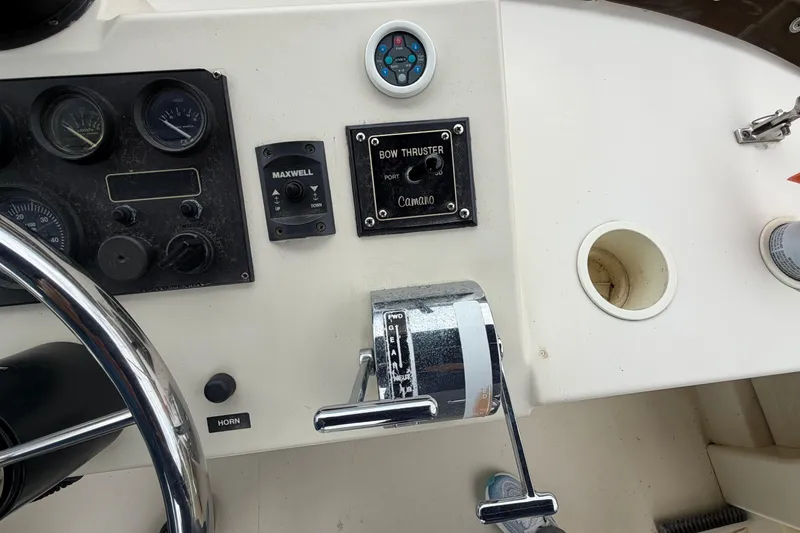 Slide: The Image of Control panel of a 2005 Camano Trawler with steering wheel and bow thruster controls. - 28