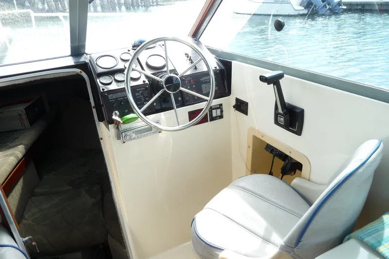 Slide: The Image of Interior cockpit of 1988 Bayliner 2102 Trophy boat with steering wheel and controls. - 10