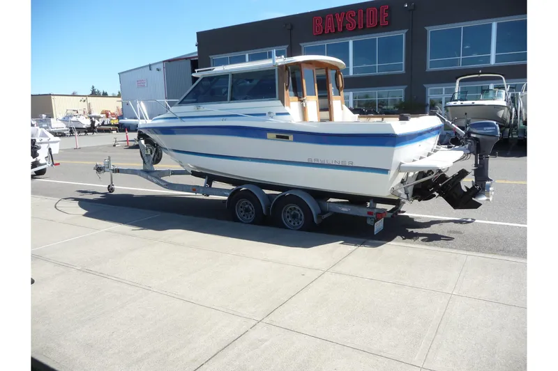 Slide: The Image of 1988 Bayliner 2102 Trophy boat on trailer outside Bayside dealership. - 2