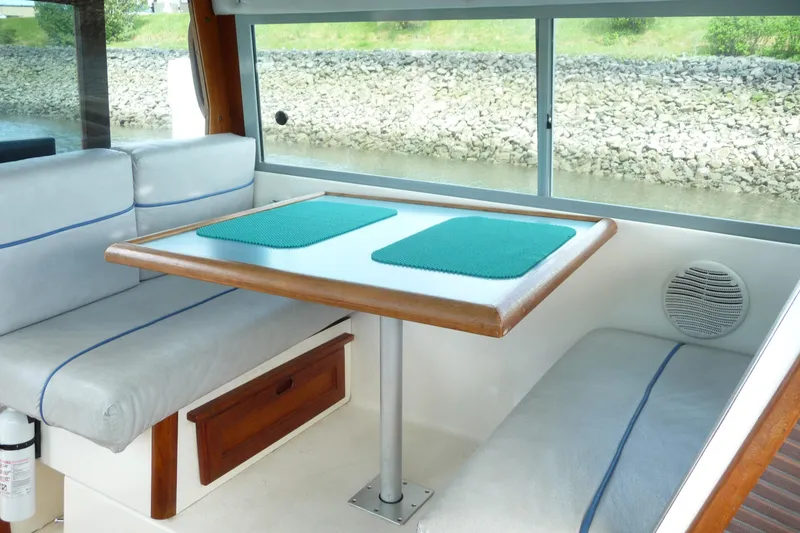 Slide: The Image of Interior of 1988 Bayliner 2102 Trophy boat with cushioned seating and table. - 9