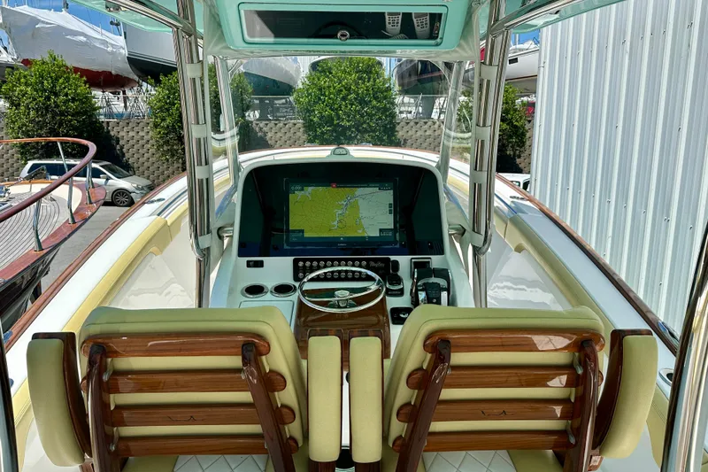 Slide: The Image of Cockpit view of 2020 Mag Bay 33 CC boat with navigation system and dual seats. - 11