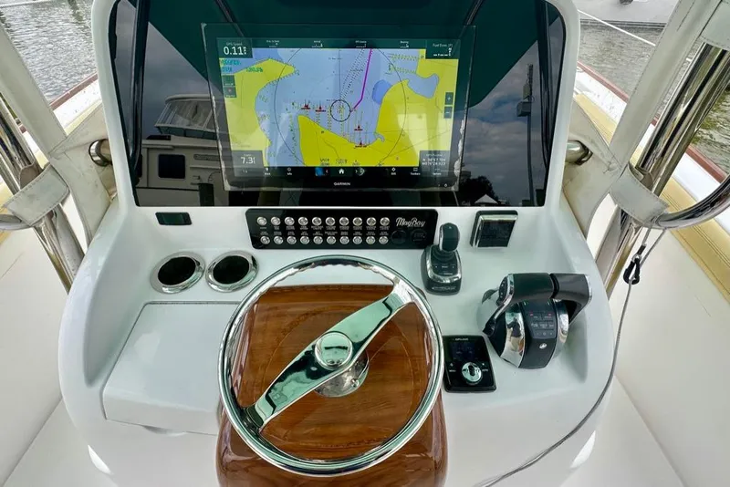 Slide: The Image of Helm of 2020 Mag Bay 33 CC with navigation display and controls. - 12