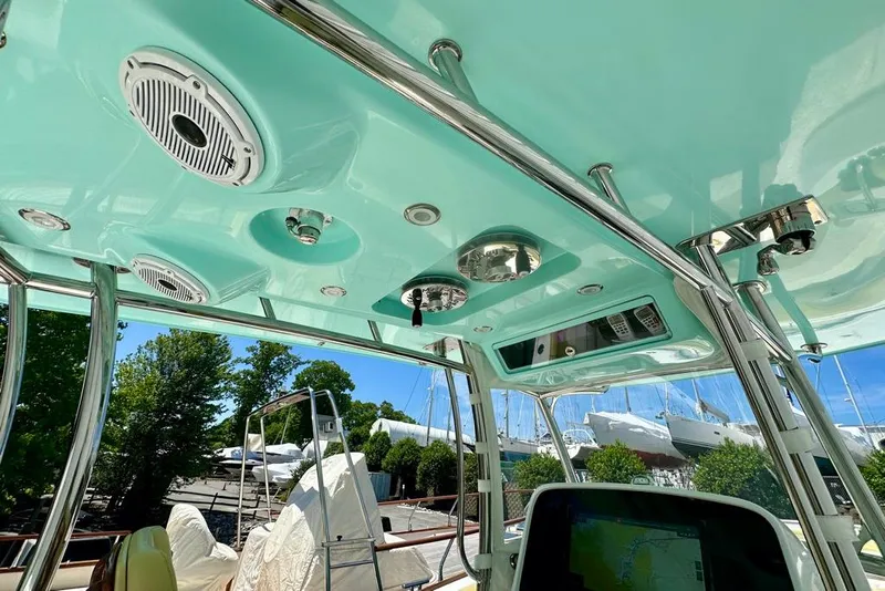 Slide: The Image of Interior view of a 2020 Mag Bay 33 CC boat, showcasing ceiling speakers and navigation equipment. - 18