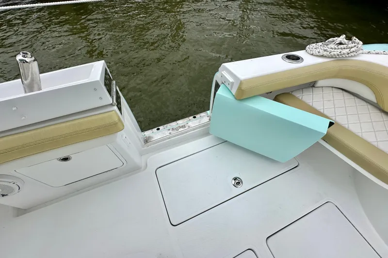 Slide: The Image of 2020 Mag Bay 33 CC boat interior with seating and storage, near water. - 21