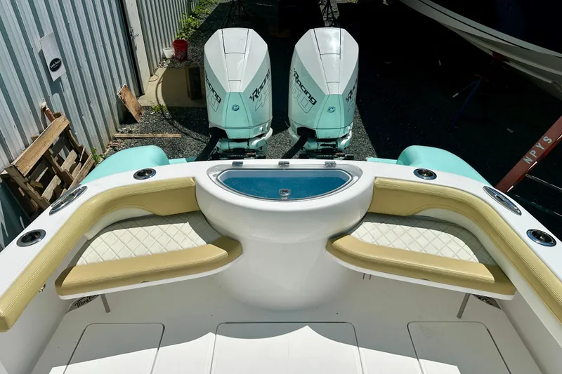 Slide: The Image of 2020 Mag Bay 33 CC boat with twin engines and cushioned seating. - 22