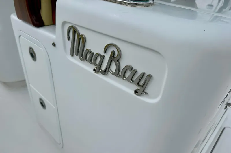 Slide: The Image of Close-up of 2020 Mag Bay 33 CC boat logo on white surface. - 23