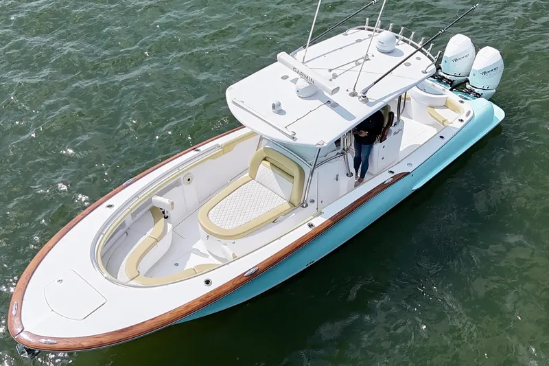 Slide: The Image of 2020 Mag Bay 33 CC boat on water, featuring sleek design and dual engines. - 5