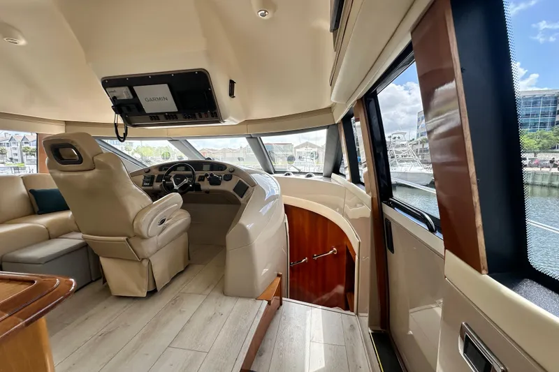 Slide: The Image of Interior view of 2006 Carver 56 Voyager yacht helm with luxurious seating and navigation equipment. - 11