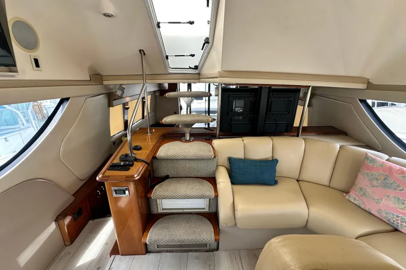 Slide: The Image of Interior of 2006 Carver 56 Voyager yacht with beige seating and elegant staircase. - 13