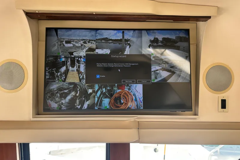 Slide: The Image of Display screen on 2006 Carver 56 Voyager showing security camera feeds and startup wizard. - 15