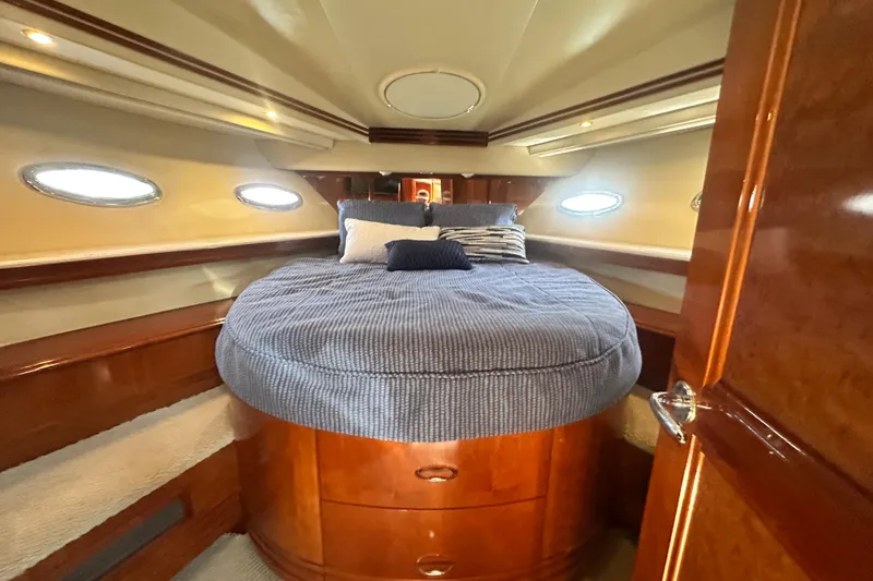 Slide: The Image of Luxurious cabin interior of a 2006 Carver 56 Voyager yacht with plush bedding. - 21