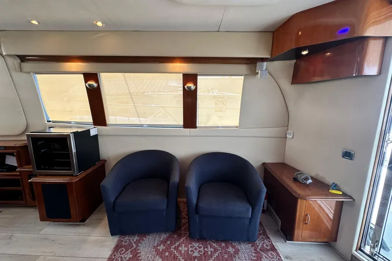 Slide: The Image of Interior of 2006 Carver 56 Voyager yacht with modern seating and wooden cabinetry. - 6