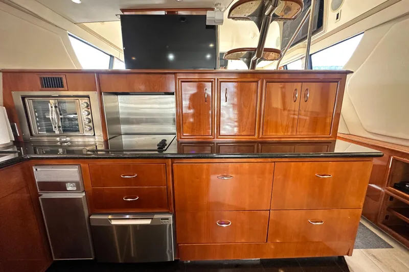Slide: The Image of Luxurious kitchen interior of 2006 Carver 56 Voyager yacht with wood cabinetry and modern appliances. - 9