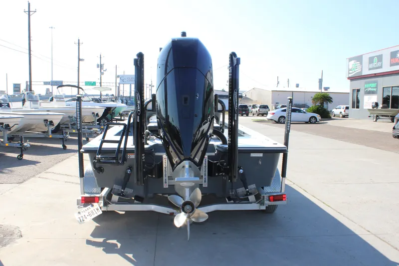 Slide: The Image of 2023 Mamba 24VX boat on trailer, rear view, in a dealership lot. - 10