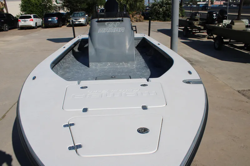 Slide: The Image of 2023 Mamba 24VX boat on display in a parking lot. - 14