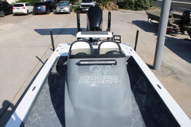 Slide: The Image of 2023 Mamba 24VX boat with sleek design and modern features, parked outdoors. - 15