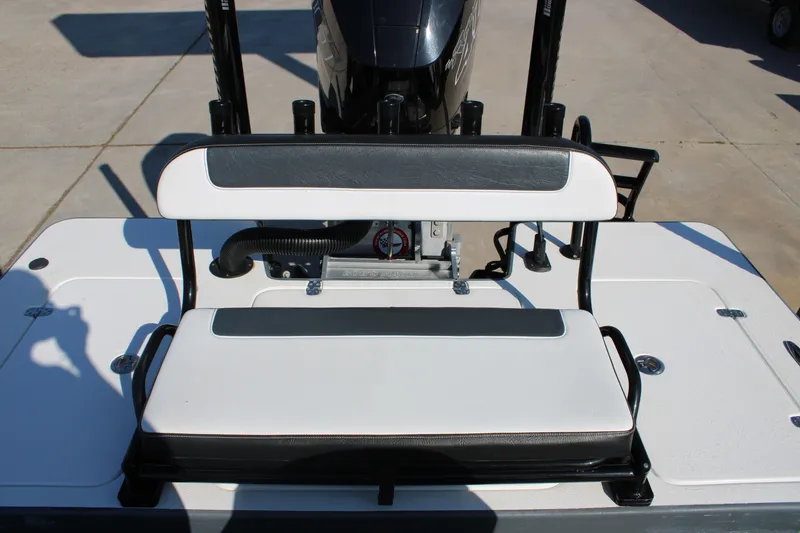 Slide: The Image of 2023 Mamba 24VX boat seat with black and white upholstery, outdoor setting. - 16