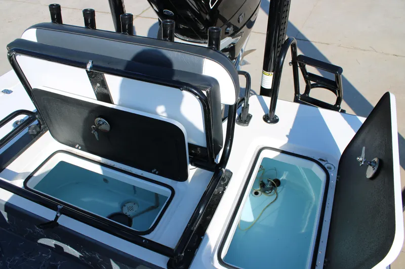 Slide: The Image of Open storage compartments on a 2023 Mamba 24VX boat, showcasing interior features. - 17