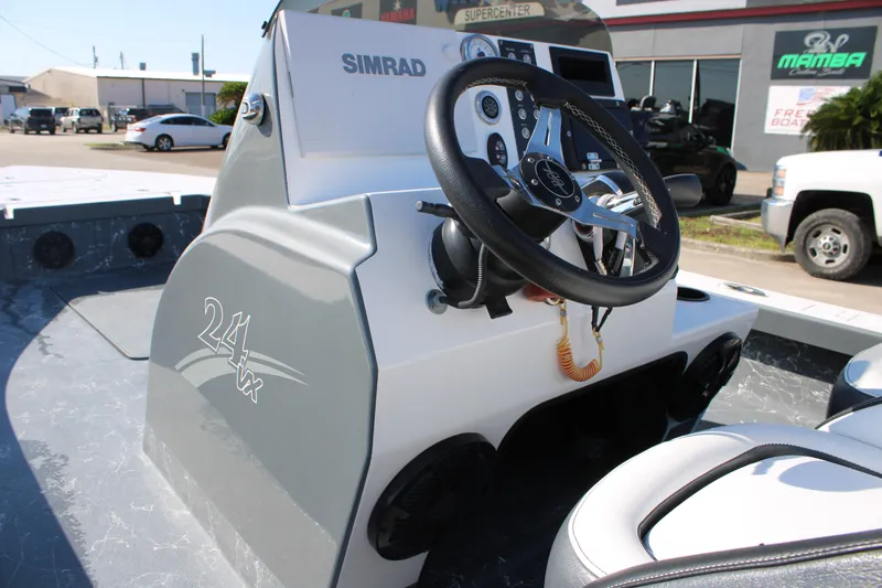 Slide: The Image of 2023 Mamba 24VX boat dashboard with steering wheel and controls. - 2