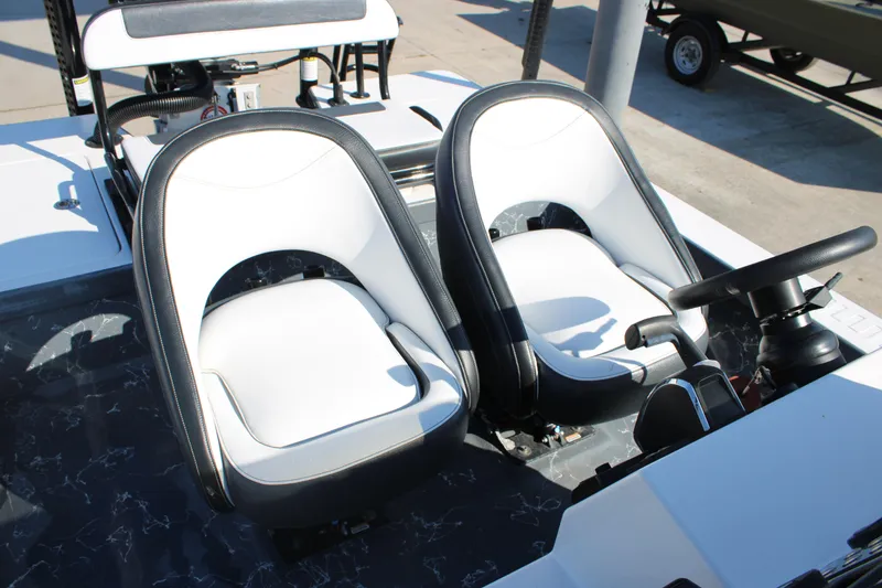 Slide: The Image of 2023 Mamba 24VX boat interior with dual white and black seats. - 3