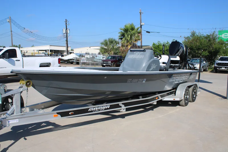 Slide: The Image of 2023 Mamba 24VX boat on trailer, parked outdoors, showcasing sleek design and modern features. - 5