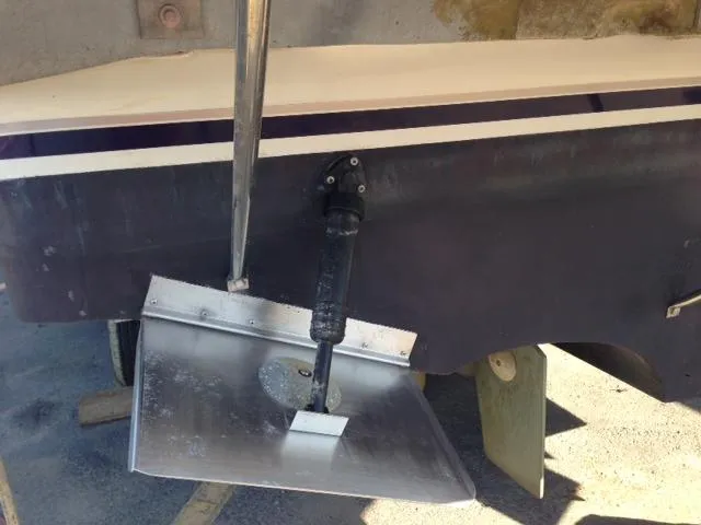Slide: The Image of Rear view of a 1995 Regal Commodore 322 boat with trim tab. - 12