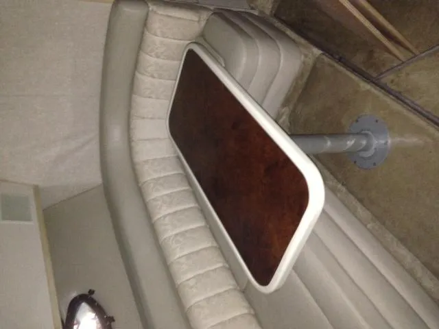 Slide: The Image of Interior of 1995 Regal Commodore 322 with cushioned seating and wooden table. - 15