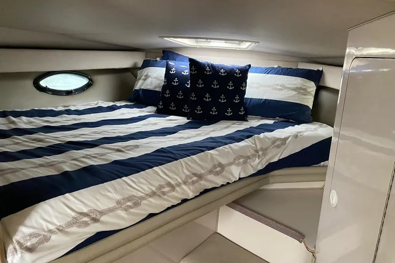 Slide: The Image of Cozy cabin bed in 1995 Regal Commodore 322 boat with nautical-themed bedding. - 19