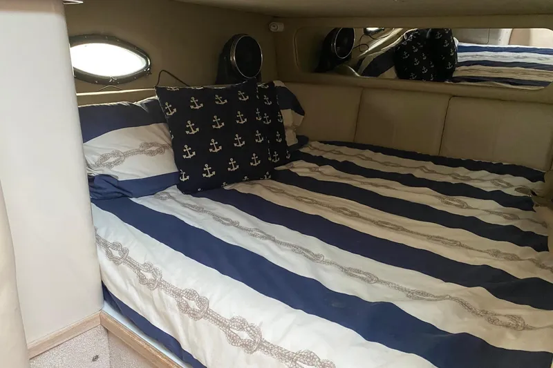 Slide: The Image of Cozy cabin bed in 1995 Regal Commodore 322 yacht with nautical-themed bedding. - 20
