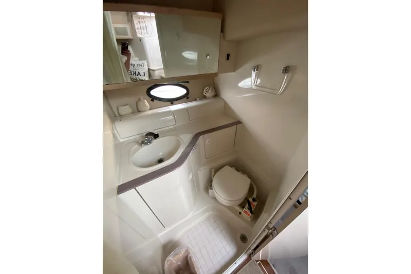 Slide: The Image of Bathroom interior of 1995 Regal Commodore 322 boat, featuring sink and toilet. - 22