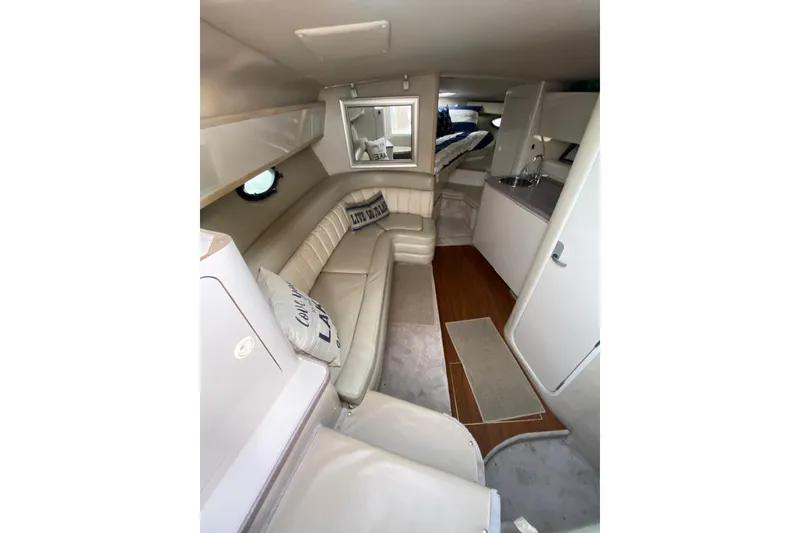 Slide: The Image of Interior of 1995 Regal Commodore 322 yacht with beige seating and compact kitchenette. - 25