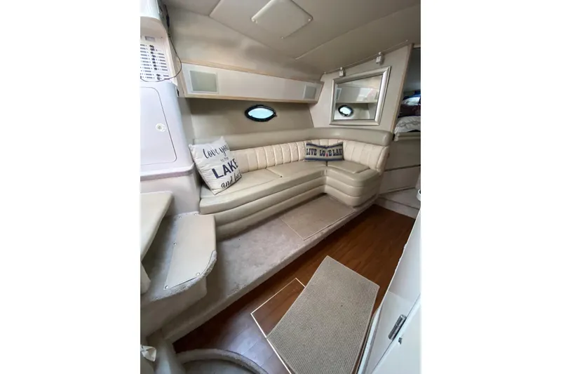 Slide: The Image of Interior of 1995 Regal Commodore 322 boat with beige seating and decorative pillows. - 26