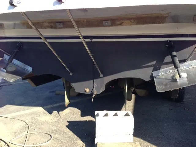 Slide: The Image of Rear view of a 1995 Regal Commodore 322 boat on a block. - 6
