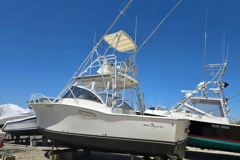 Slide: The Image of 2003 Albemarle 305 Express Fisherman boat on dry dock under clear blue sky. - 1