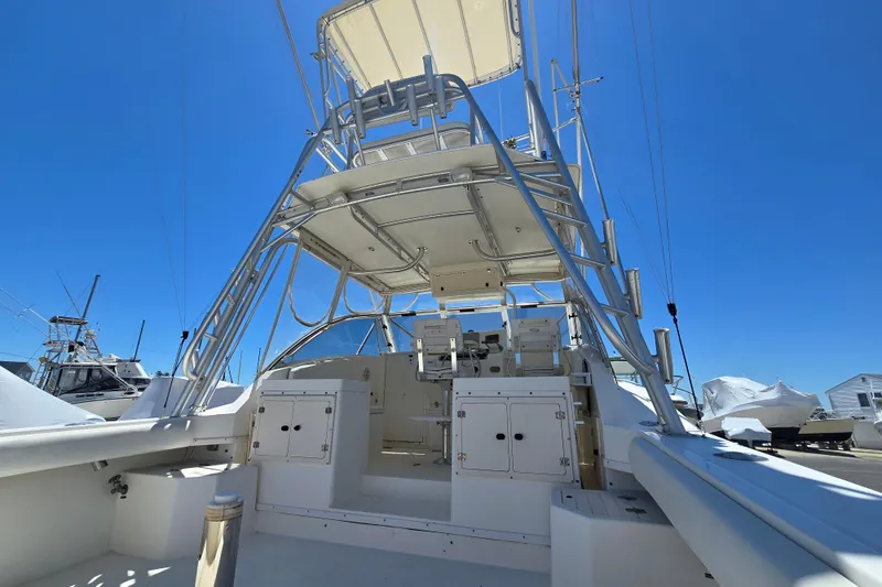 Slide: The Image of 2003 Albemarle 305 Express Fisherman boat with tower under clear blue sky. - 13