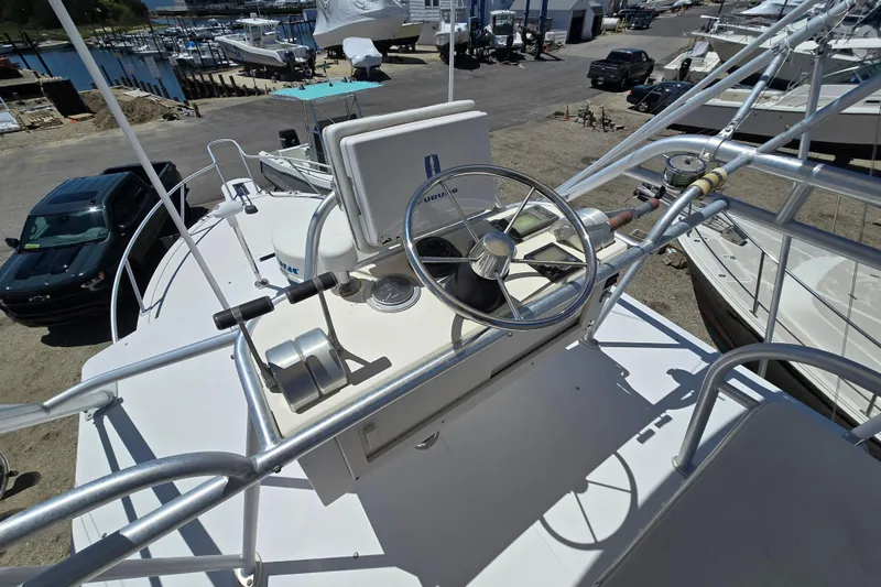 Slide: The Image of 2003 Albemarle 305 Express Fisherman boat helm with steering wheel and controls. - 16
