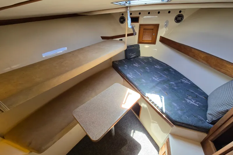 Slide: The Image of 2003 Albemarle 305 Express Fisherman cabin interior with seating and table. - 18