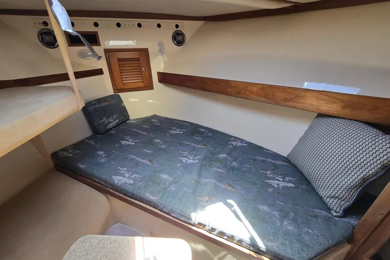 Slide: The Image of 2003 Albemarle 305 Express Fisherman cabin interior with cozy bed and wooden accents. - 19
