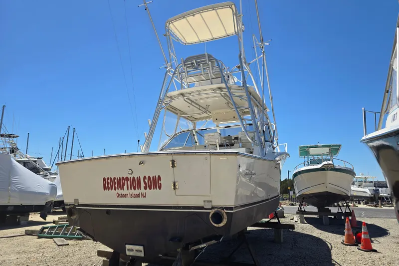 Slide: The Image of 2003 Albemarle 305 Express Fisherman boat on land, named "Redemption Song," Osborn Island, NJ. - 2