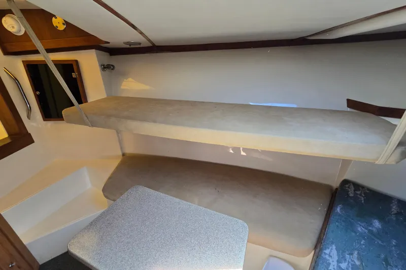 Slide: The Image of Interior cabin of 2003 Albemarle 305 Express Fisherman with bunk beds and table. - 20