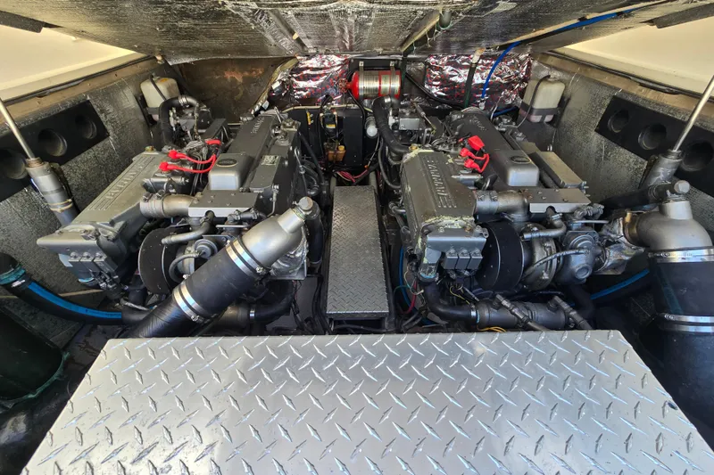 Slide: The Image of Engine compartment of 2003 Albemarle 305 Express Fisherman, showcasing dual engines and mechanical components. - 25