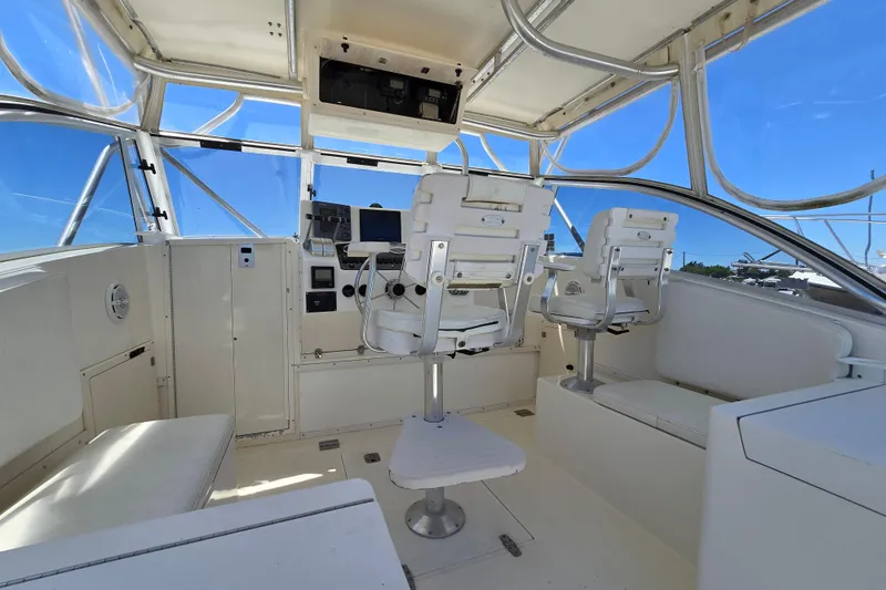 Slide: The Image of 2003 Albemarle 305 Express Fisherman cockpit with helm chairs and navigation equipment. - 6