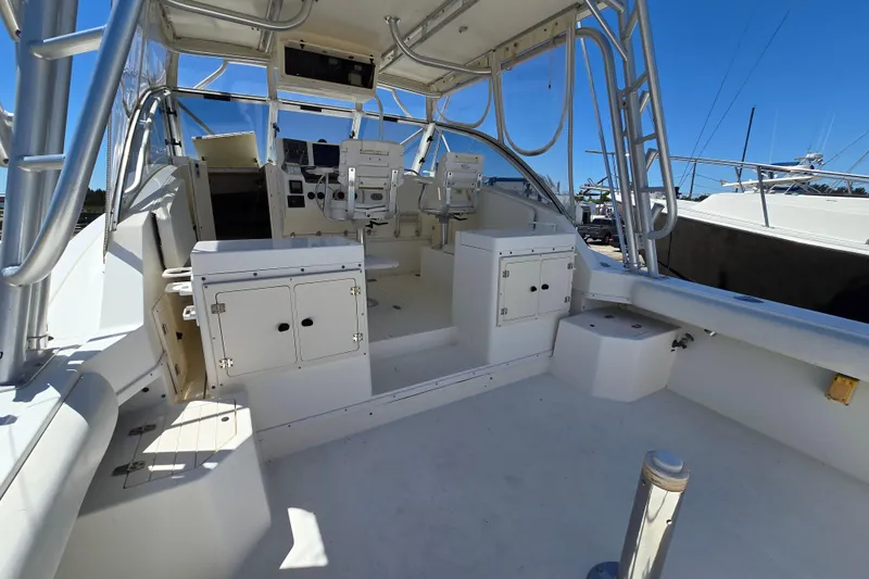 Slide: The Image of 2003 Albemarle 305 Express Fisherman boat interior with helm and seating area. - 7