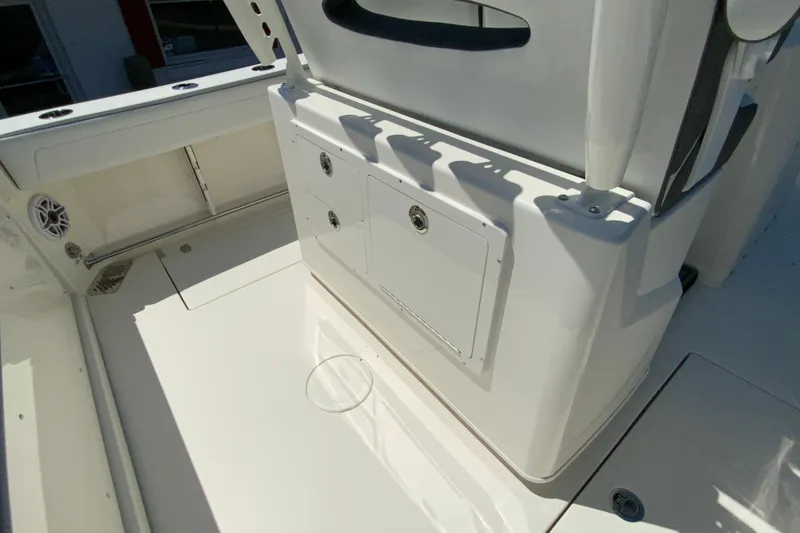 Slide: The Image of 2026 Cobia 245 Center Console boat interior with storage compartments and seating. - 16