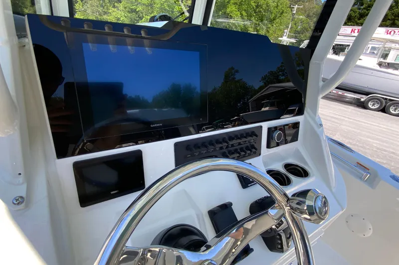 Slide: The Image of 2026 Cobia 245 Center Console dashboard with Garmin navigation and control panel. - 20