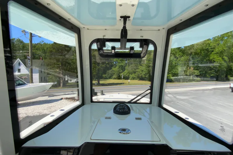 Slide: The Image of Interior view of 2026 Cobia 245 Center Console boat with clear windows and compass. - 22
