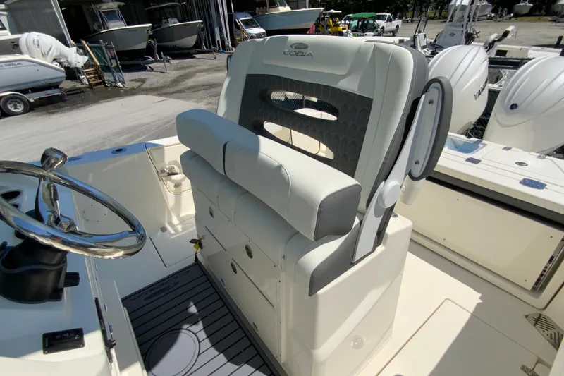 Slide: The Image of 2026 Cobia 245 Center Console boat interior with steering wheel and seating. - 24