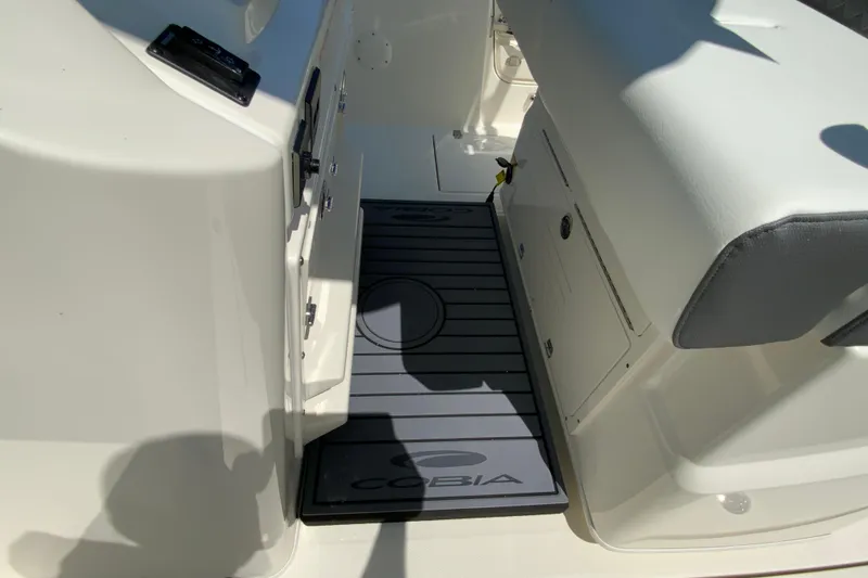 Slide: The Image of Interior view of 2026 Cobia 245 Center Console boat, featuring seating and storage. - 26