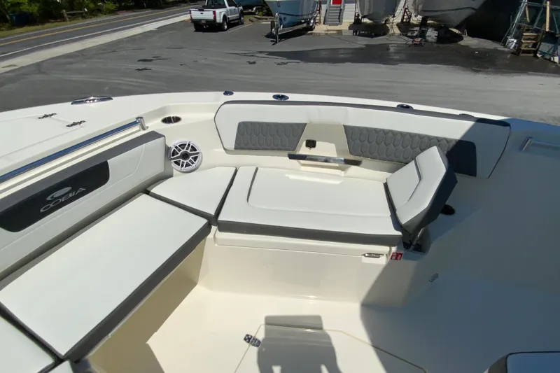 Slide: The Image of 2026 Cobia 245 Center Console boat interior with cushioned seating and speaker. - 29