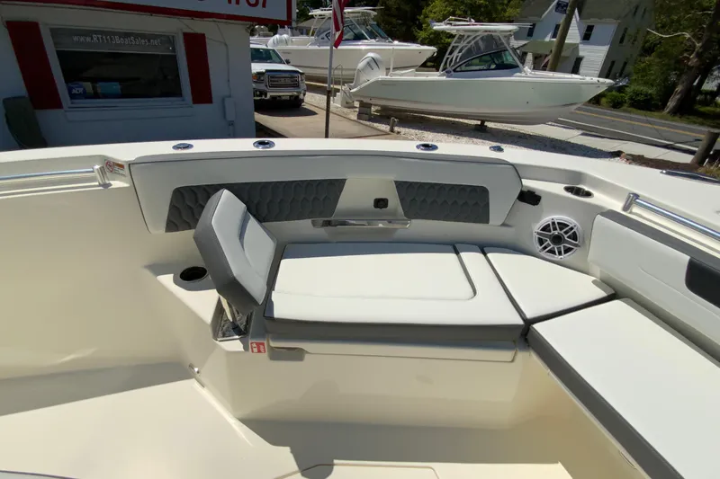 Slide: The Image of 2026 Cobia 245 Center Console boat interior with cushioned seating and speaker system. - 30